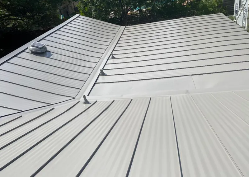 Solar attic fan installed on a metal roof for Roof Ventilation in Pace